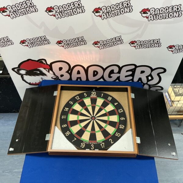 Vintage wooden dartboard cabinet with a classic dartboard.