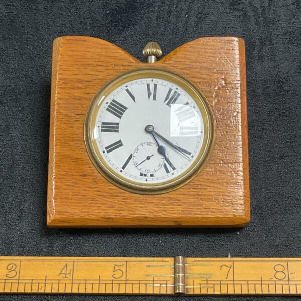 Vintage wooden desk clock with Roman numerals.
