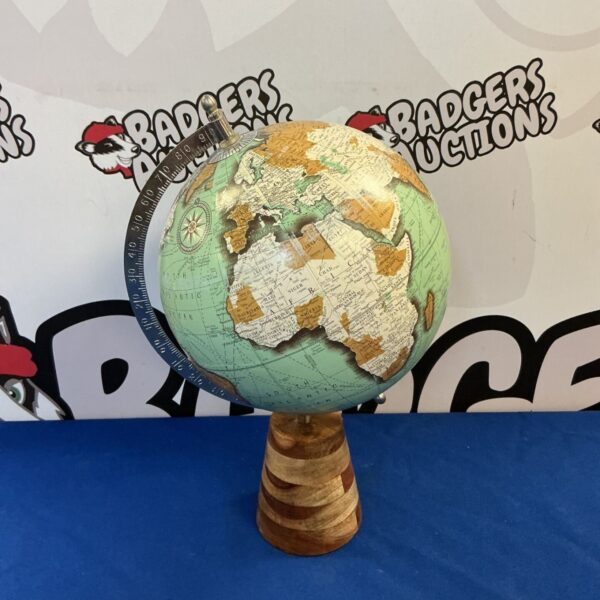 Vintage desktop world globe on hardwood base, detailed geographical map.