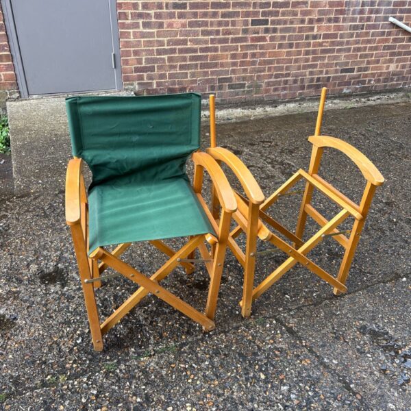 Pair of vintage directors chairs with wooden frames and canvas seats.