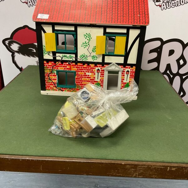 Vintage dolls house with miniature furniture included, a collectible toy.