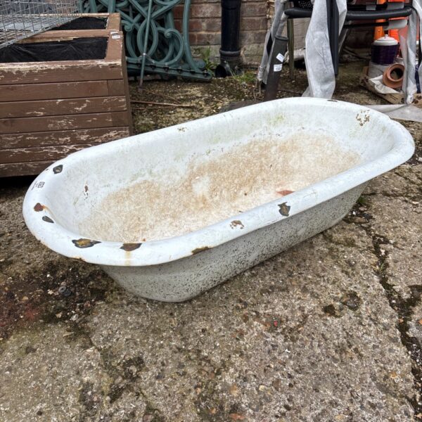 Vintage enamelled baby bath with signs of wear and rust.