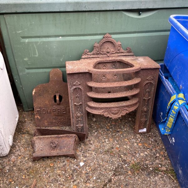 Antique wrought iron fire grate with floral detailing.