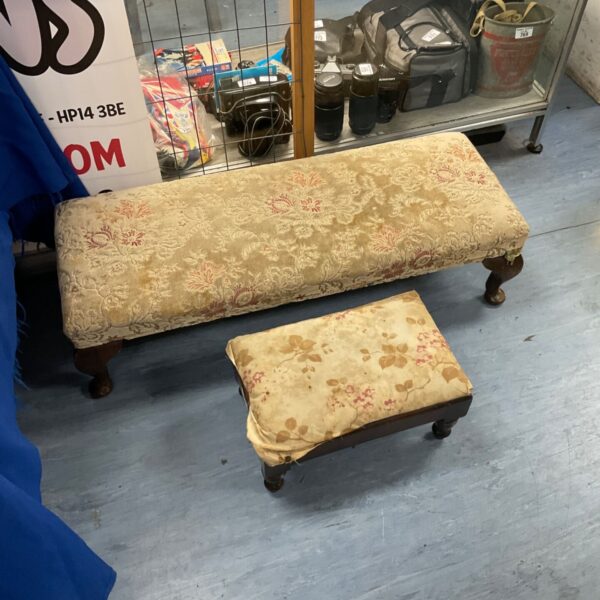 Vintage floral footstool with turned wooden legs.