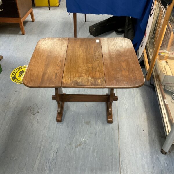 Vintage wooden folding occasional table with a twist-top design.