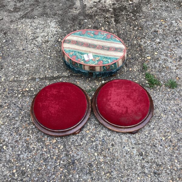 Set of three vintage red foot stools for home decor.