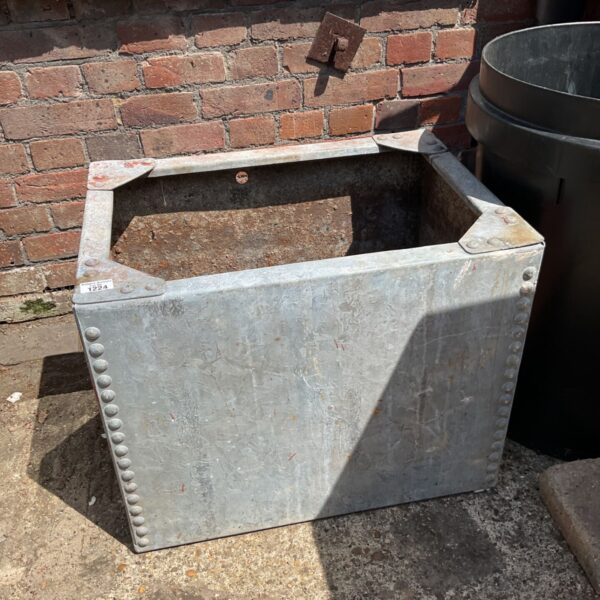 Vintage galvanised metal water tank with signs of age.