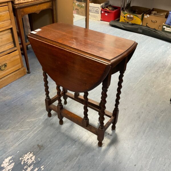 Vintage barley twist gate leg table in wood.