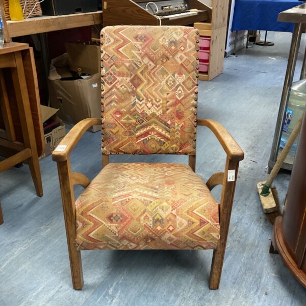 Vintage geometric lounge chair with patterned upholstery and wood frame.