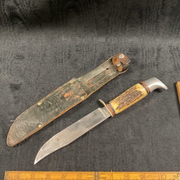 Vintage German hunting knife with horn handle and leather sheath.