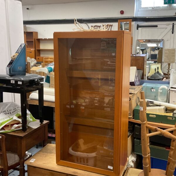 Vintage wooden glass fronted display cabinet for collectibles.