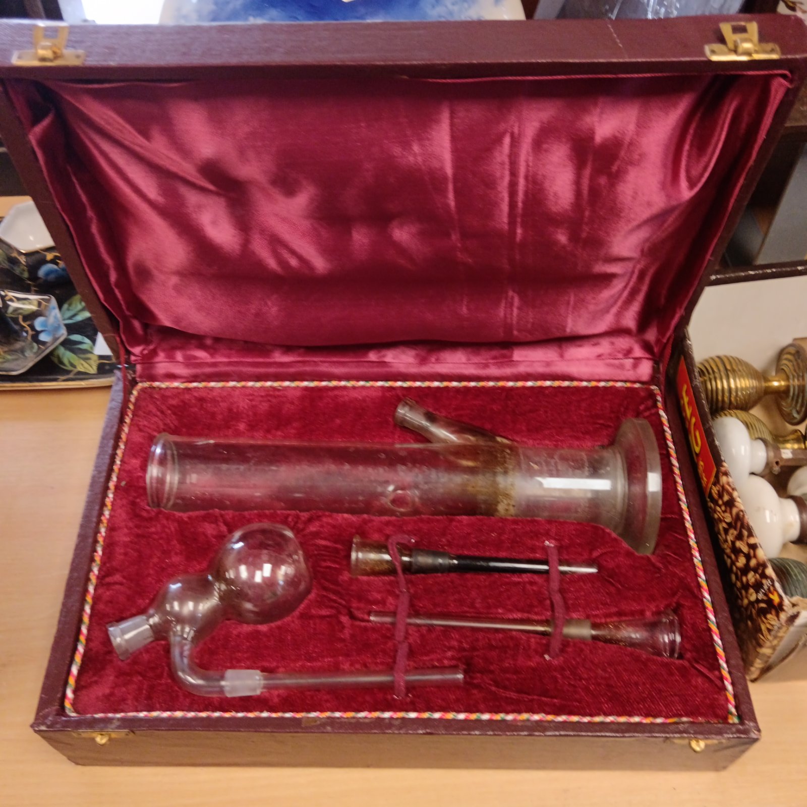 Vintage glass pipe displayed in a red velvet lined case.
