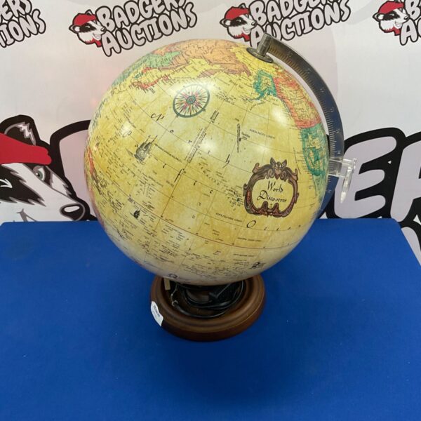Vintage illuminated world globe on wooden base, a unique desk lamp.