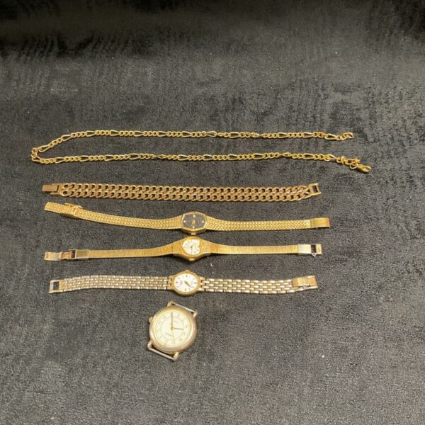 Vintage gold tone watch lot with Figaro necklace displayed.
