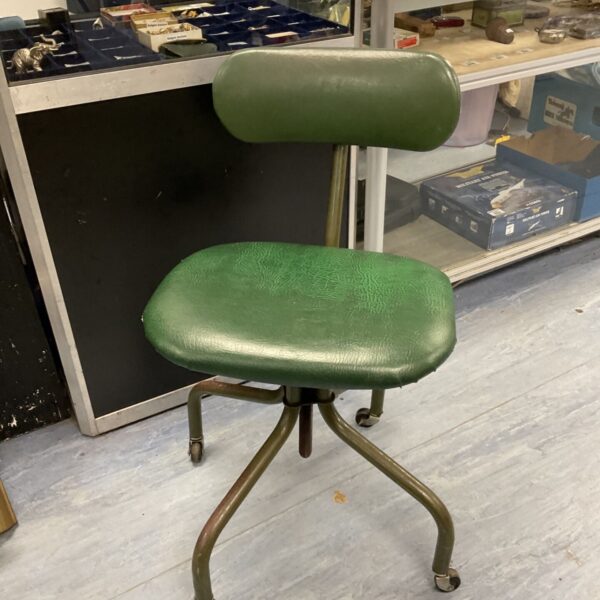 Vintage green swivel desk chair with metal base.