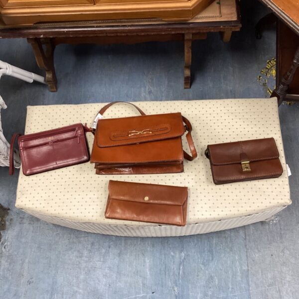 Vintage lot of brown leather handbags and clutches for collectors.