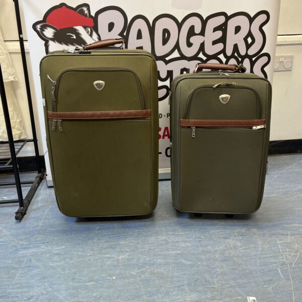 Vintage green IT suitcases on wheels, a collectible travel lot.