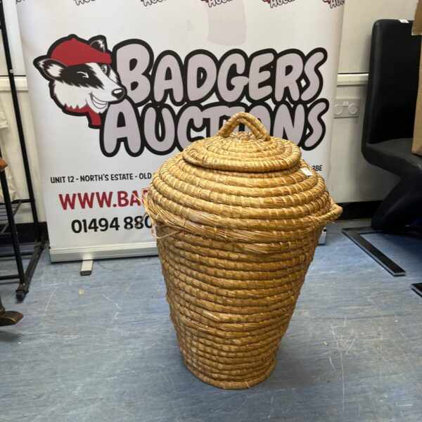 Tall vintage linen basket with woven texture, ideal for farmhouse decor.