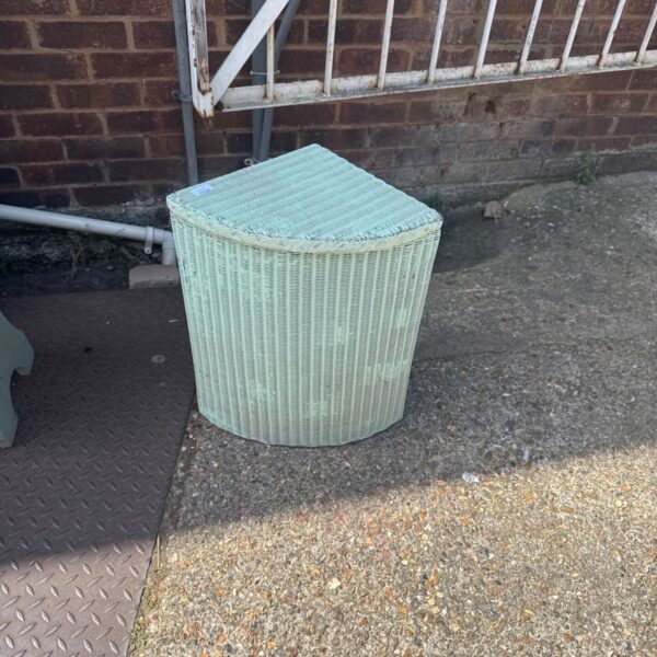 Vintage pale green Lloyd Loom linen basket for corner storage.
