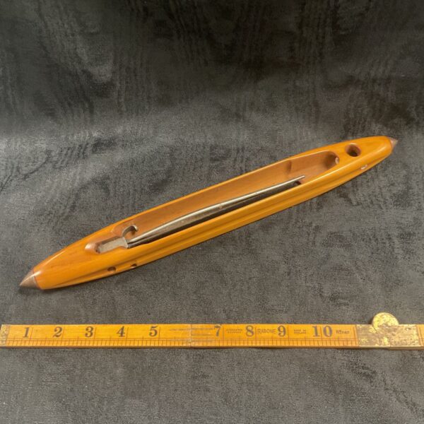 Vintage wooden loom shuttle by Croft of Sheffield, a classic weaving tool.