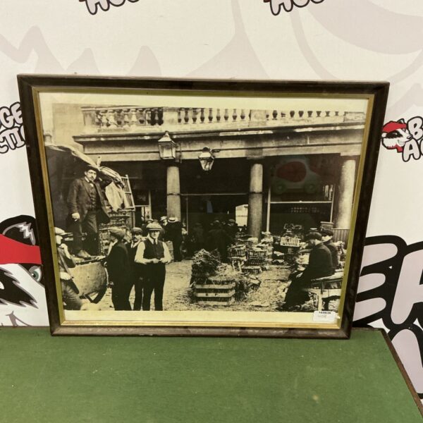 Vintage framed print of a bustling market scene with workers.