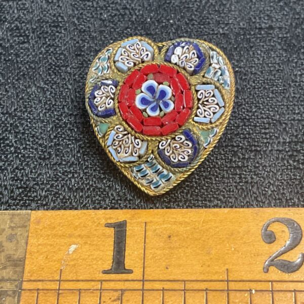 Vintage millafiori heart brooch with colourful floral details.