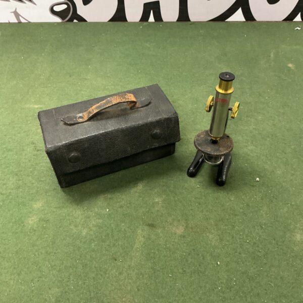 Vintage octopus miniature microscope in wooden case.