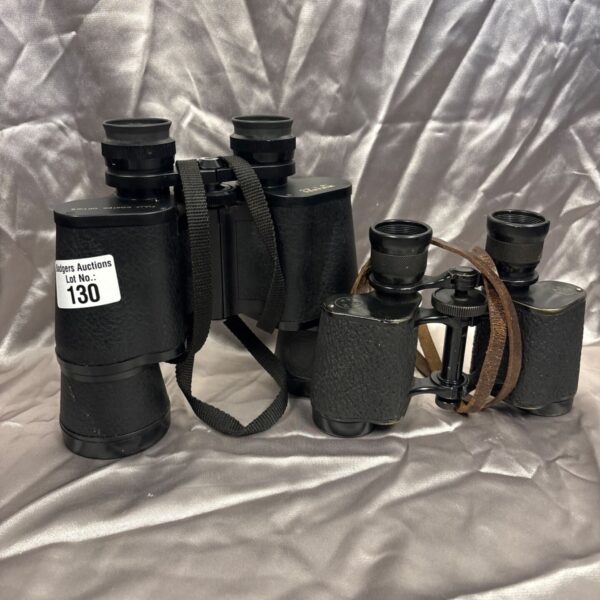 Vintage Miranda binoculars with a neck strap, showing signs of age.