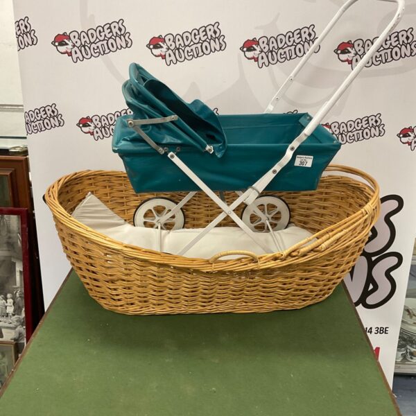 Vintage Moses basket pram with woven basket and metal frame.