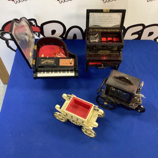 Vintage musical jewellery box with decorative detailing and a wind-up mechanism.
