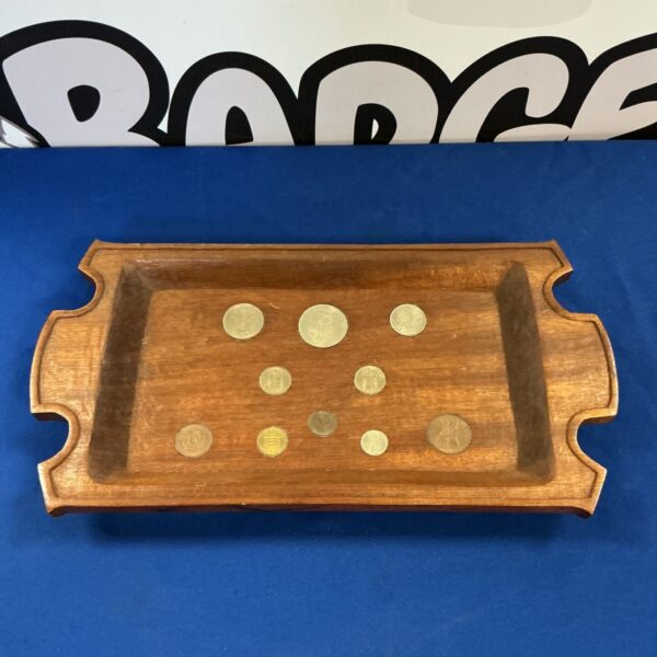 Vintage oak tray displaying old English coins, a collectible item.