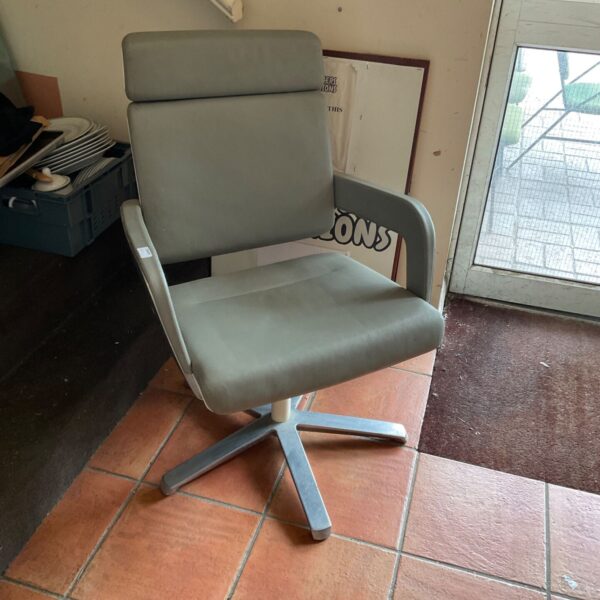 Vintage swivel office chair with a neutral upholstered seat.