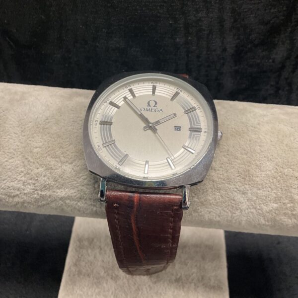 Vintage Omega Seamaster Deville watch with baton hands and leather strap.