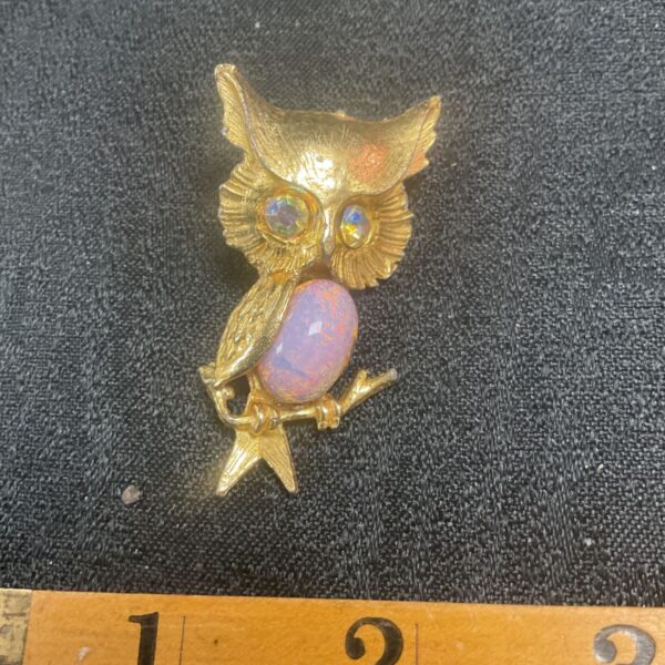Vintage gold owl brooch with cabochon stone body.