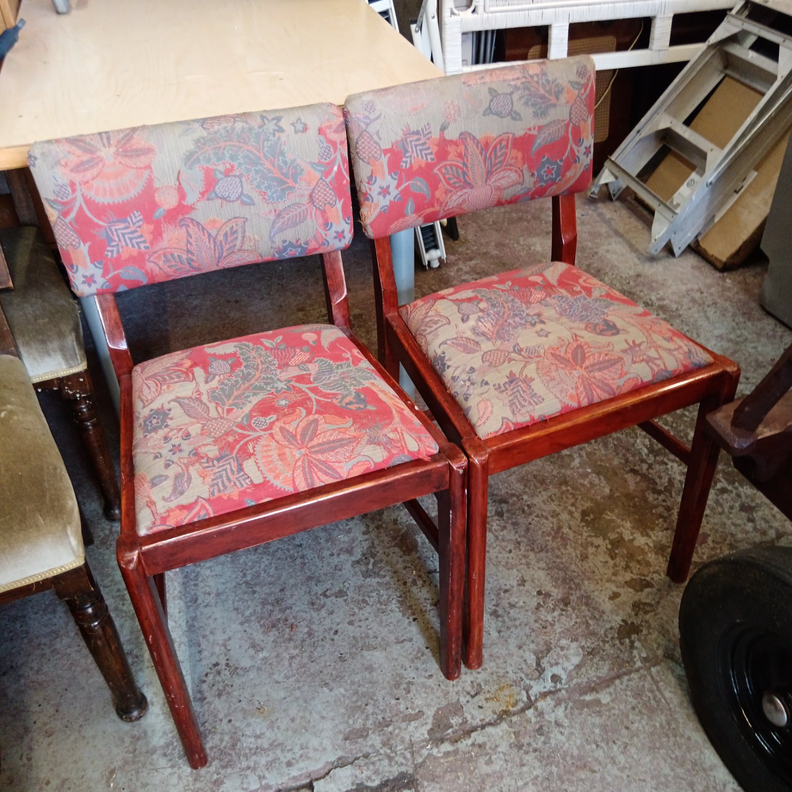 Pair of vintage paisley dining chairs with wood frames.