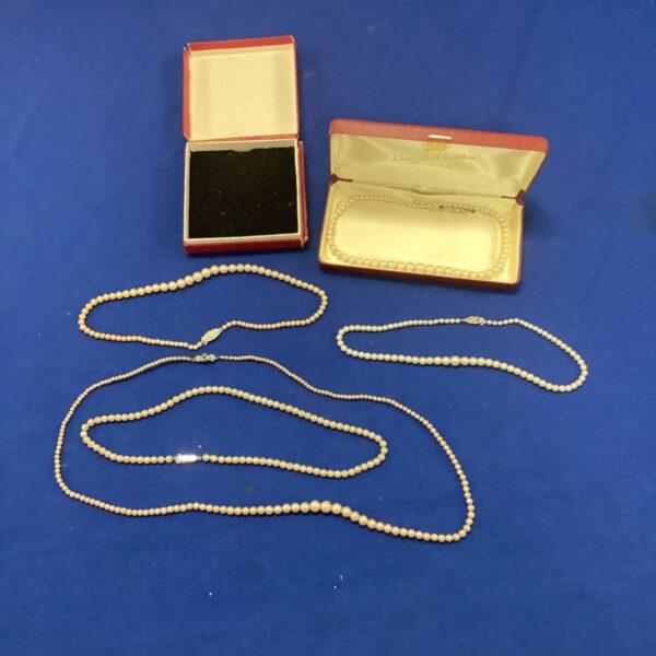 Vintage pearl necklace displayed in its original pale blue box.