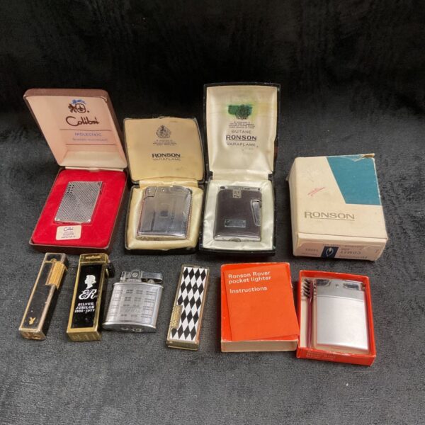 Vintage petrol lighters including Colibri and Ronson brands in original packaging.