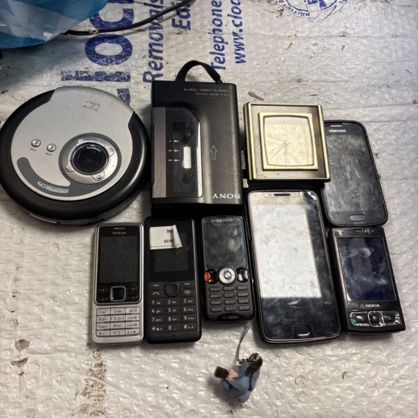 Vintage lot of Nokia mobile phones and Sony cassette player.