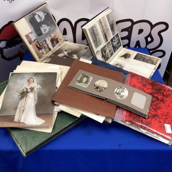 Collection of vintage photo albums with pre-war photographs.