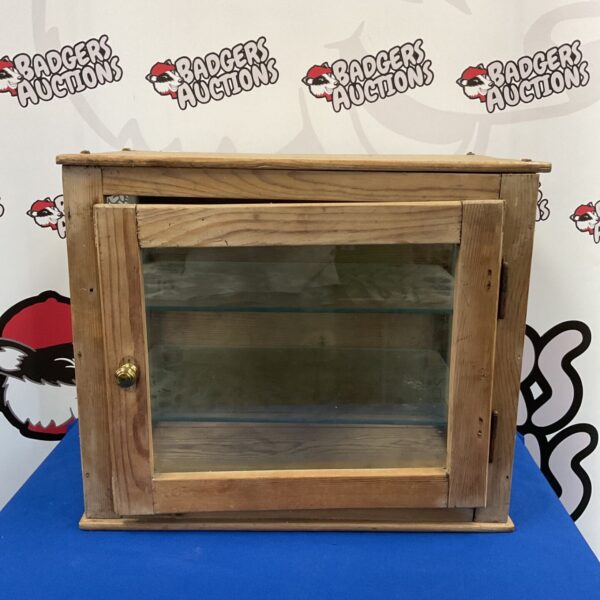 Vintage pine display case with glass front and shelves.