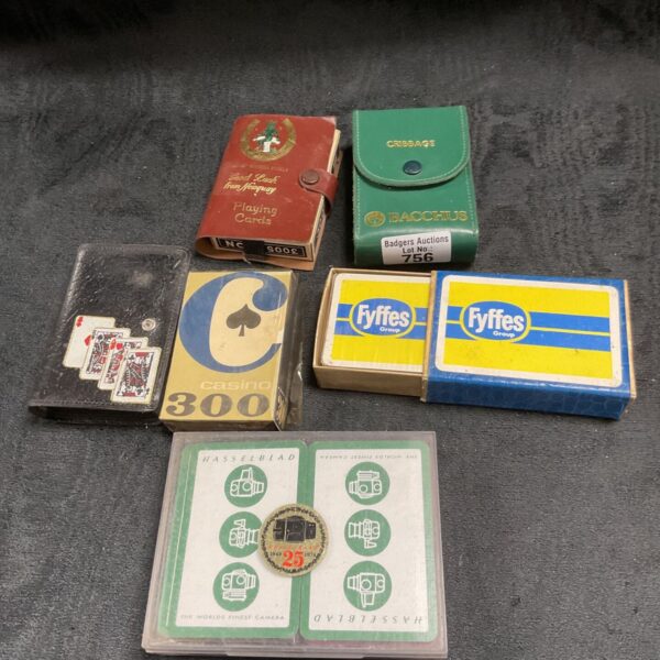 Vintage playing cards lot featuring sealed Fyffes and Casino 300 packs.