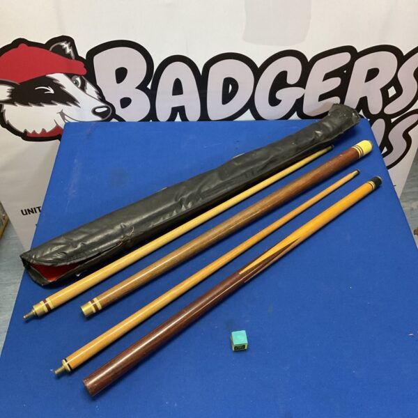 Pair of vintage pool cues with wood shafts and decorative bands.