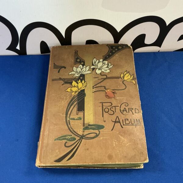 Vintage postcard album with Art Nouveau cover design.