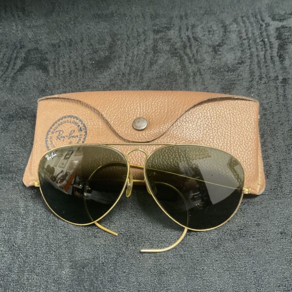 Vintage Ray-Ban aviator sunglasses with leather case displayed.