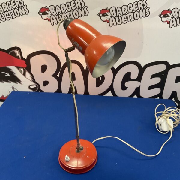 Red vintage metal desk lamp with adjustable arm.