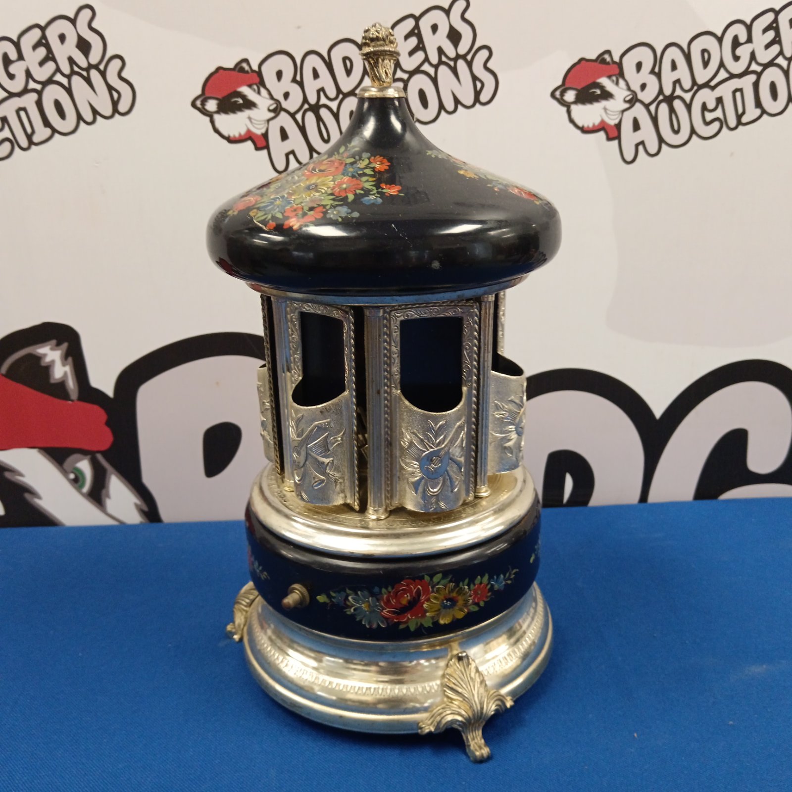Vintage Reuge carousel music box with floral details.
