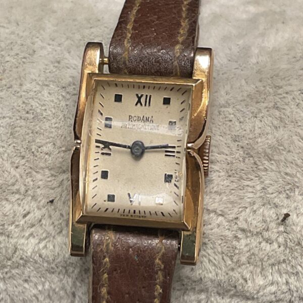 Vintage Rodana ladies wristwatch with gold case and leather strap.