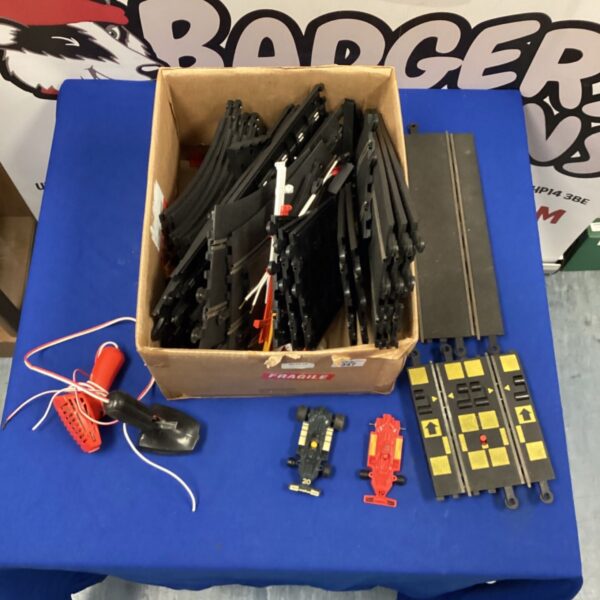 Vintage Scalextric track set with cars and controllers in a box.