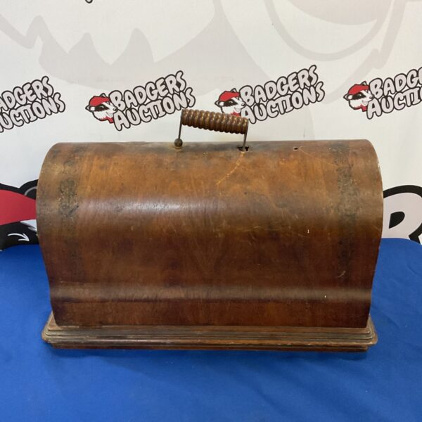 Vintage sewing machine in locked wooden case, retro collectible.