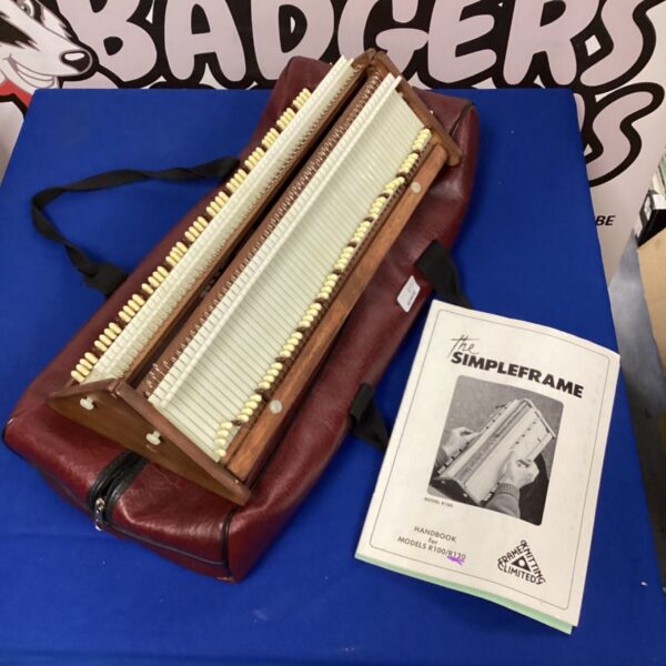 Vintage Simpleframe accordion with dark leatherette casing and button keys.